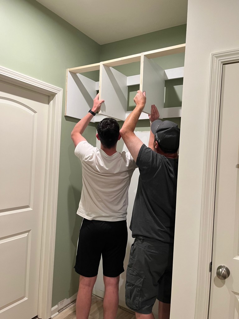 2 men placing bench in niche