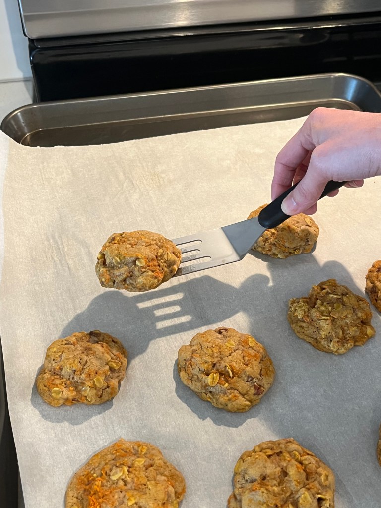 Taking cookies off pan to cool